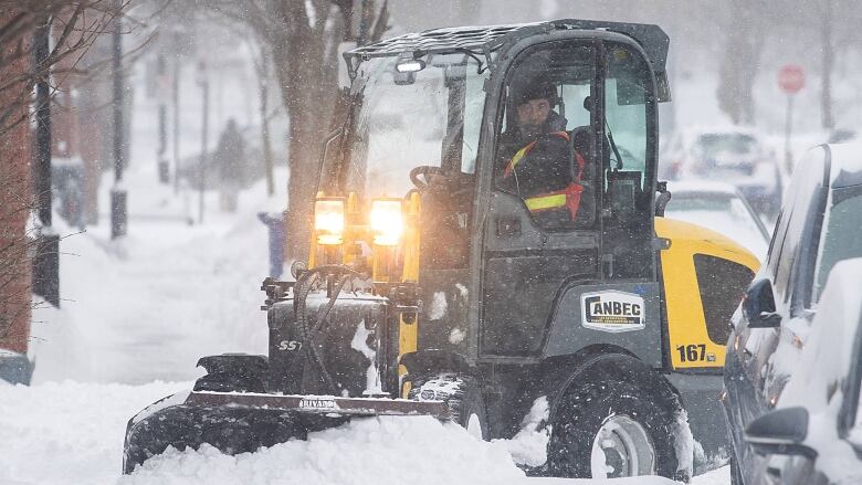 Sidewalk plow in heavy snow.