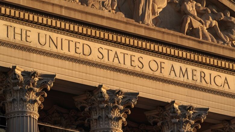 The stone facade of a building, with the etched words 'The United States of America.'