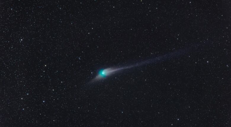 A green orb against a black sky specked with stars. 