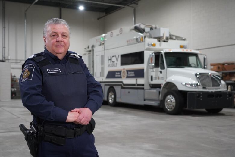 A man standing in front  of a truck