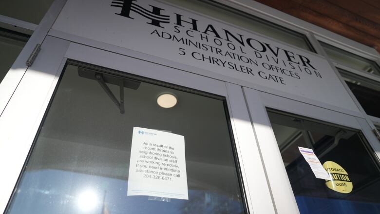 A notice is posted on the door of the Hanover School Division that says, 