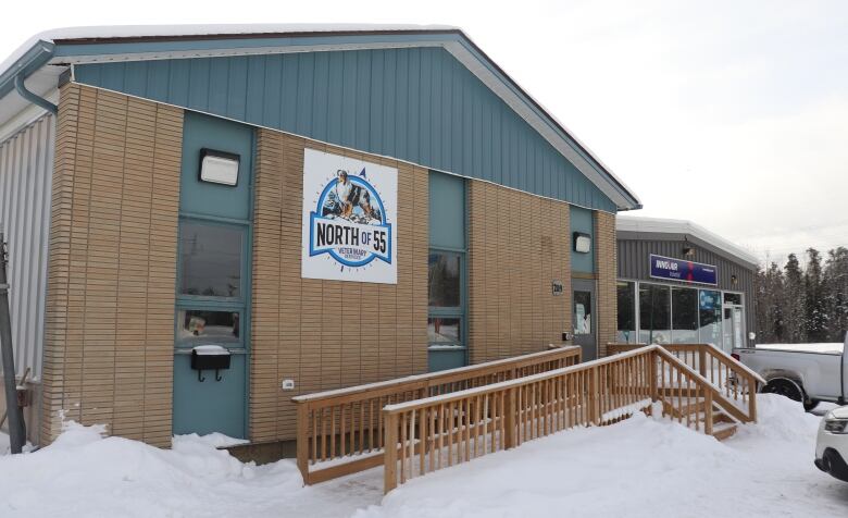 A brown and green building with a sign that reads 'North of 55 Veterinary Clinic'