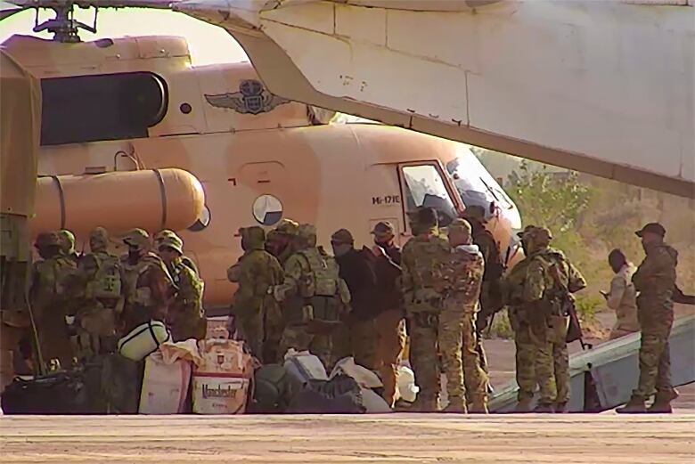 This undated photograph handed out by French military shows Russian mercenaries boarding a helicopter in northern Mali. Russia's Wagner Group, a private military company led by Yevgeny Prigozhin, a rogue millionaire with longtime links to Russia's President Vladimir Putin, has played a key role in the fighting in Ukraine and also has deployed its personnel to Syria, Central African Republic, Libya and Mali.