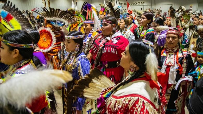 Dancers enter the powwow arena for Grand Entry.