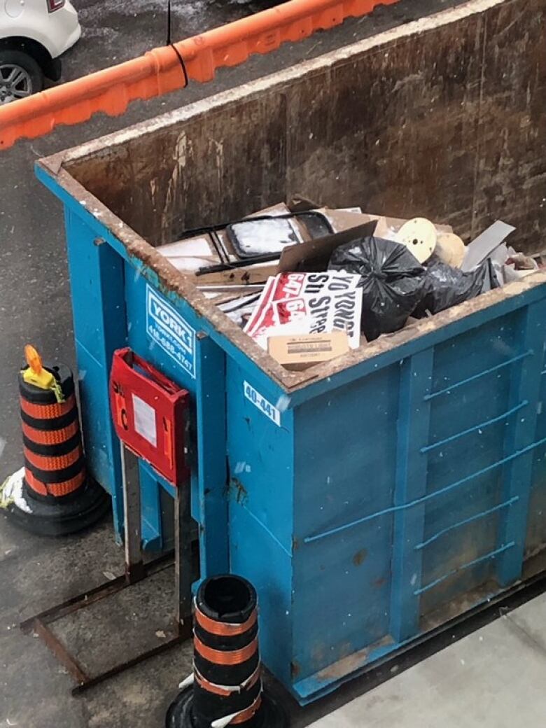 Signs in dumpster