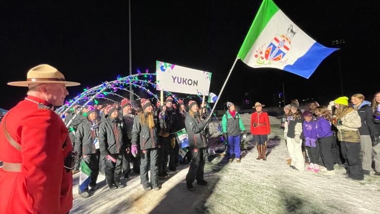 A group of people wave a flag.