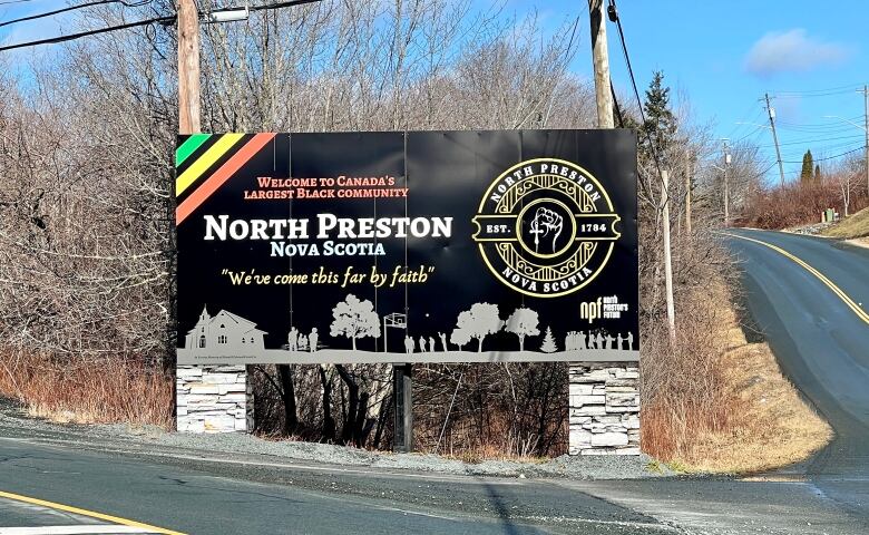 An outdoor sign says 'Welcome to Canada's largest Black community: North Preston, Nova Scotia. We've come this far by faith.'