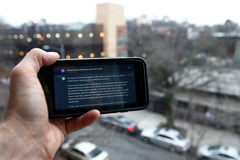 A ChatGPT prompt is shown on a mobile device near a public school in Brooklyn, New York.