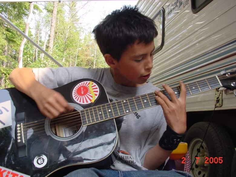 Child with guitar.