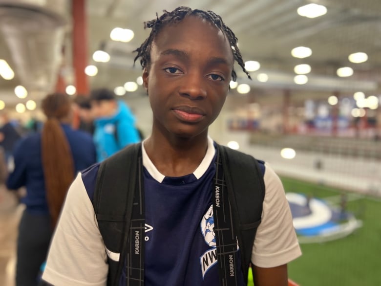 A portrait of a youth wearing a jersey.