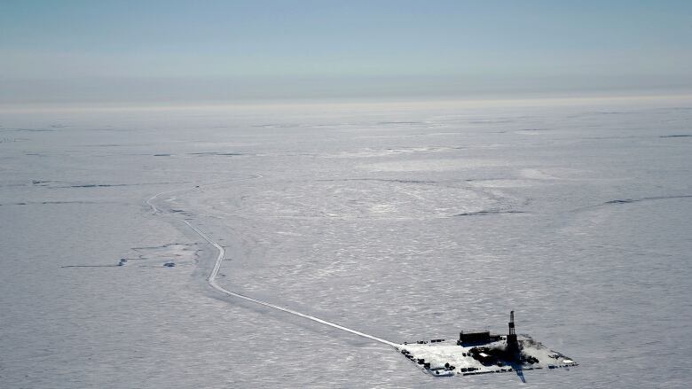 A tiny oil rig in a vast square of snow and ice. 