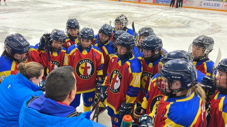 Team huddle with coaches.