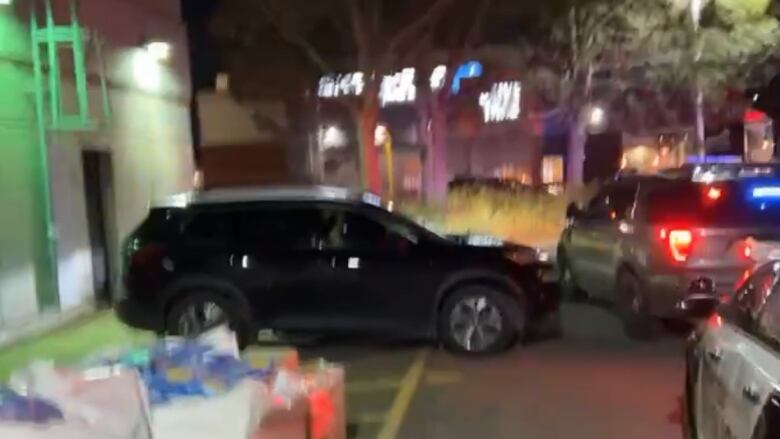 Halton police look through the stolen car behind a Petro-Canada gas station in Oakville.