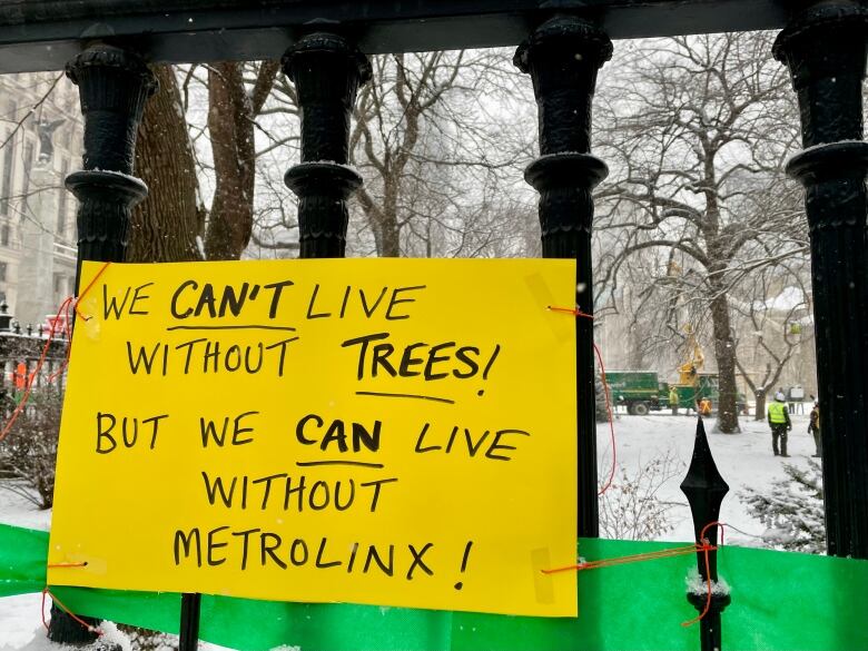 A sign is pictured near Osgoode Hall as Metrolinx begins the removal of centuries-old trees early Saturday morning.