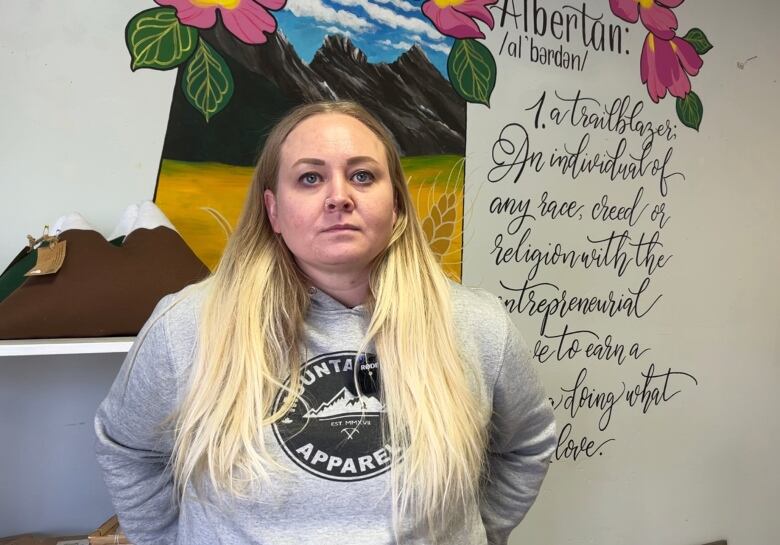 Lindsey Cybulskie stands in front of a mural inside her Airdrie homewares store.