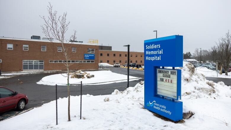 A hospital in wintertime with snow in the foreground.