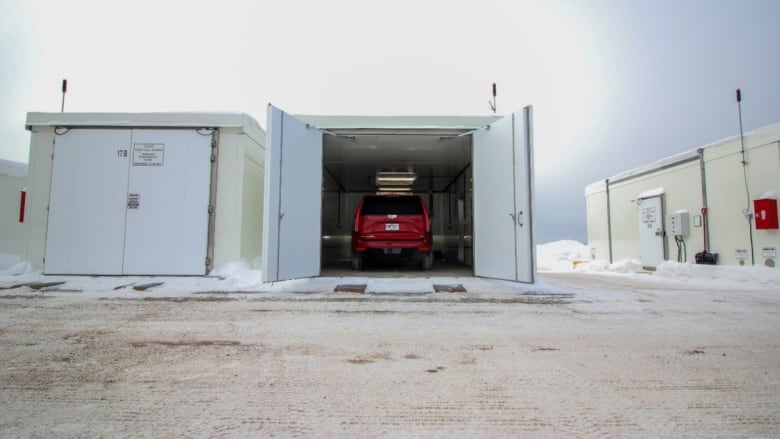 A red vehicle in a large freezer.