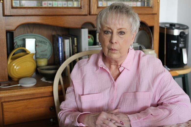 Janice Rourke sits in the dining room of her downtown Calgary apartment.