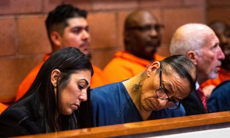 Nathan Chasing Horse is pictured in court sitting beside a woman. 