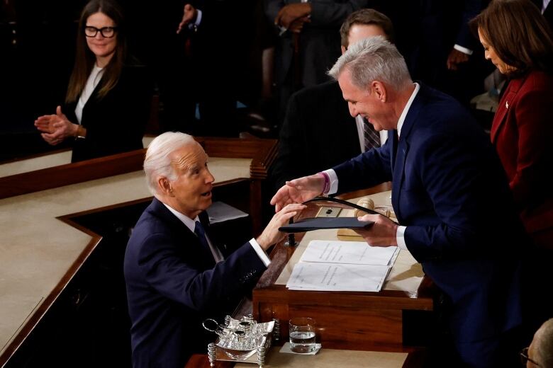 U.S. President Joe Biden hands a copy of the speech to U.S. Speaker of the House Kevin McCarthy (R-CA) prior to delivering State of the Union address his State of the Union address at the U.S. Capitol in Washington, U.S., February 7, 2023. REUTERS/Evelyn Hockstein