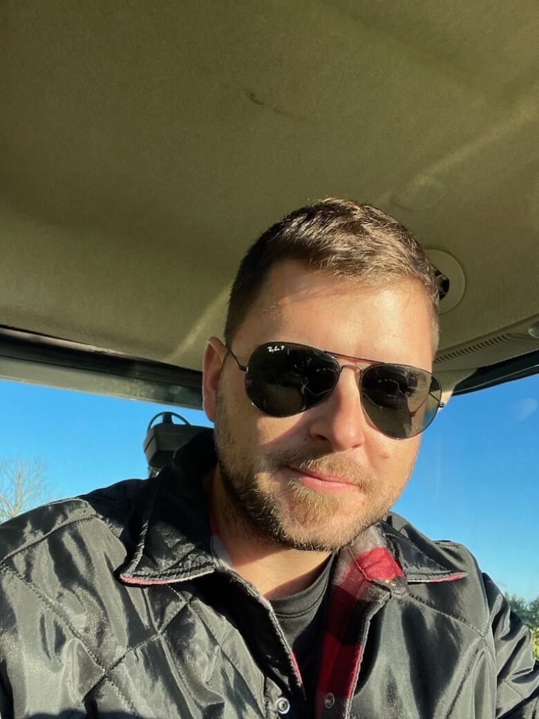 A man sits in his tractor.