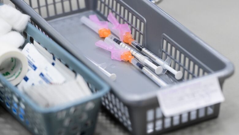 A file photo shows a basket of COVID-19 doses, waiting to be administered to patients, at an Ottawa clinic, in March 2021.