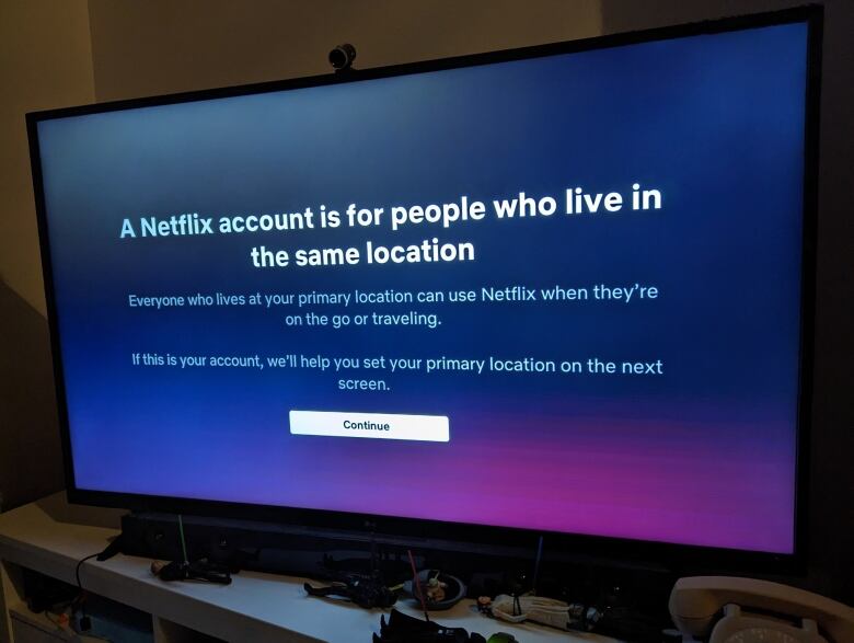 A TV screen shows an error message from Netflix about how the system is only designed to be used by people at the same residence.