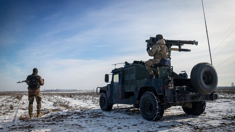 Two Ukrainian soldiers scan the horizon outside Kyiv on Feb. 9, 2023 for approaching drones  terror weapons Russia has used to target civilian infrastructure.