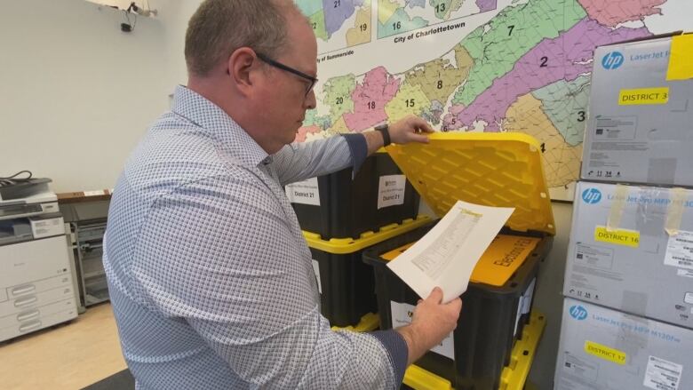 Elections P.E.I. chief electoral officer Tim Garrity looks over some documents.