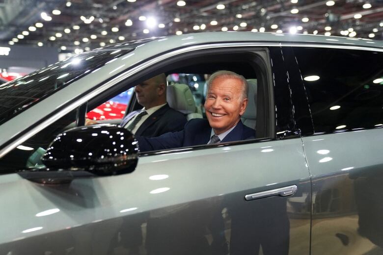 U.S. President Joe Biden drives a Cadillac LYRIQ electric SUV during a visit to the Detroit Auto Show, to highlight electric vehicle manufacturing in America, in Detroit, Michigan, U.S., September 14, 2022. REUTERS/Kevin Lamarque