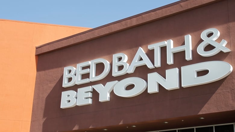 A white sign for Bed Bath & Beyond is pictured on a store front. 