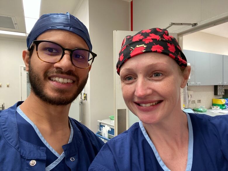 Dr. Kate Stewart and her husband, Dr. Chamath De Silva, are pictured in an operating room.