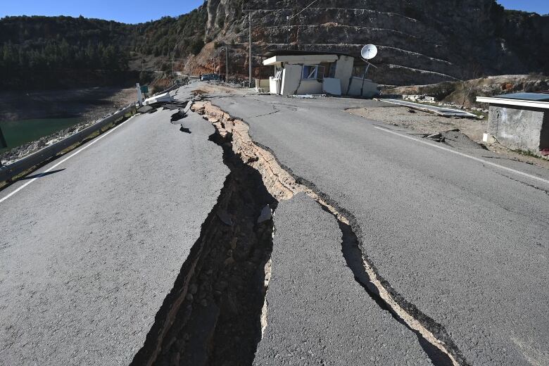 A giant crevice in a roadway is shown