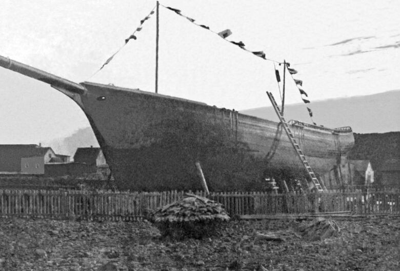 An old black and white picture of a schooner under construction.