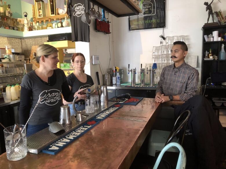 People at a bar in a restaurant. 