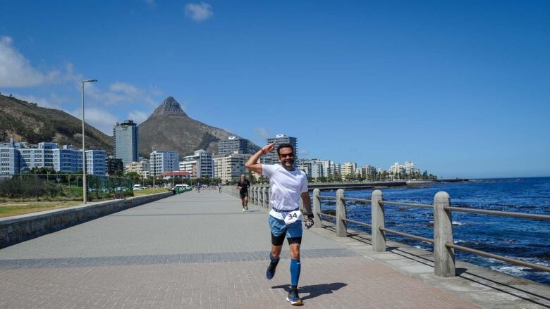 A man runs along a boardwalk.