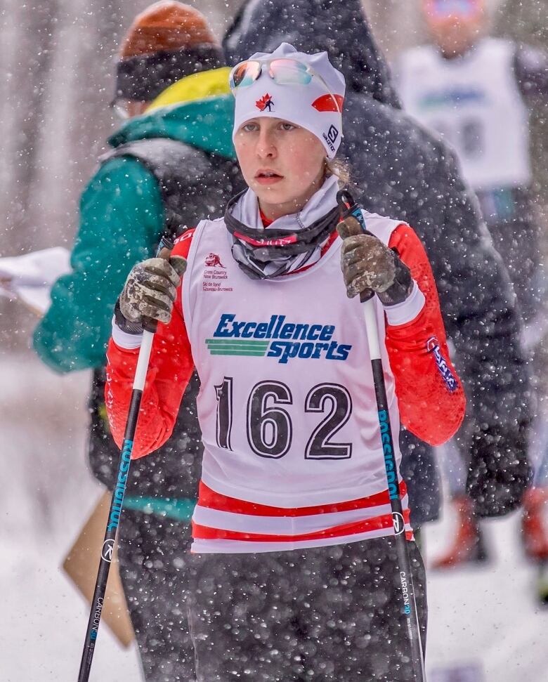 A person skiing outside during daylight while it's snowing.