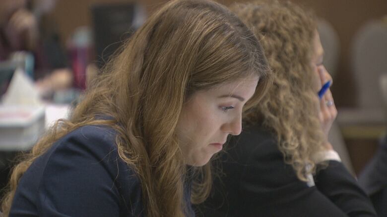 A side profile of a woman with long light brown hair