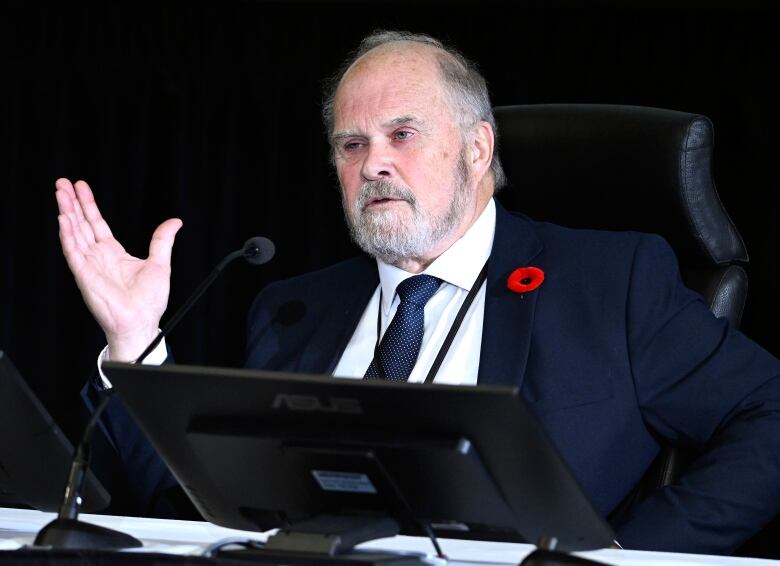 A man speaks in front of a microphone.