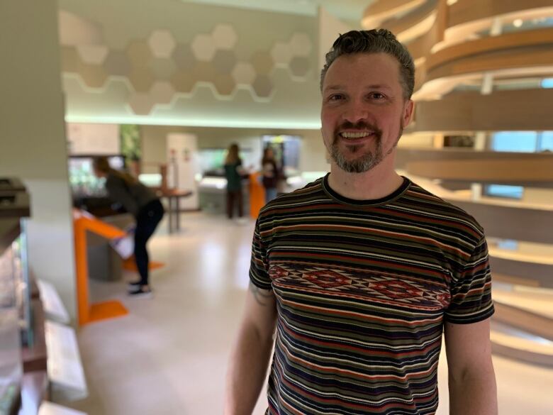 A man stands in the insect room at a museum in Alberta.