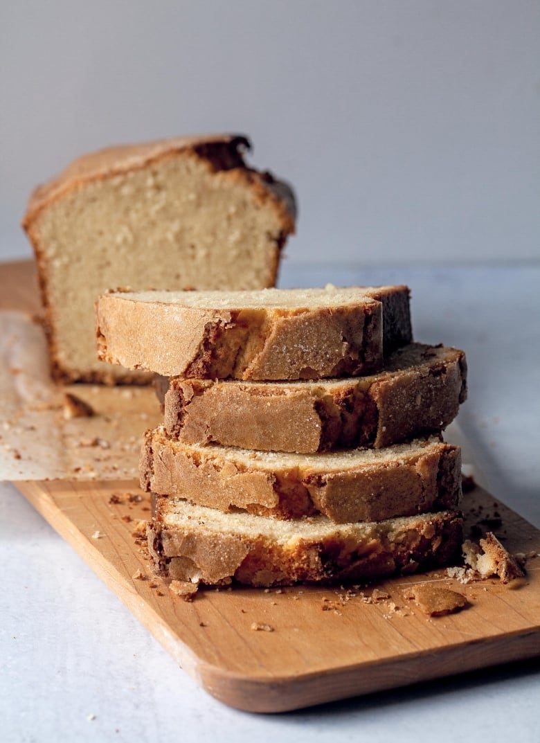 a sliced pound cake loaf on a wooden cutting board