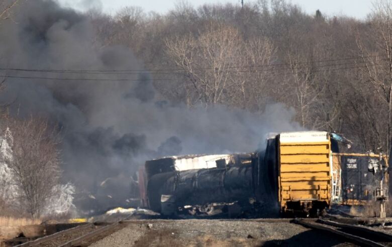 A derailed freight car lies on its side.