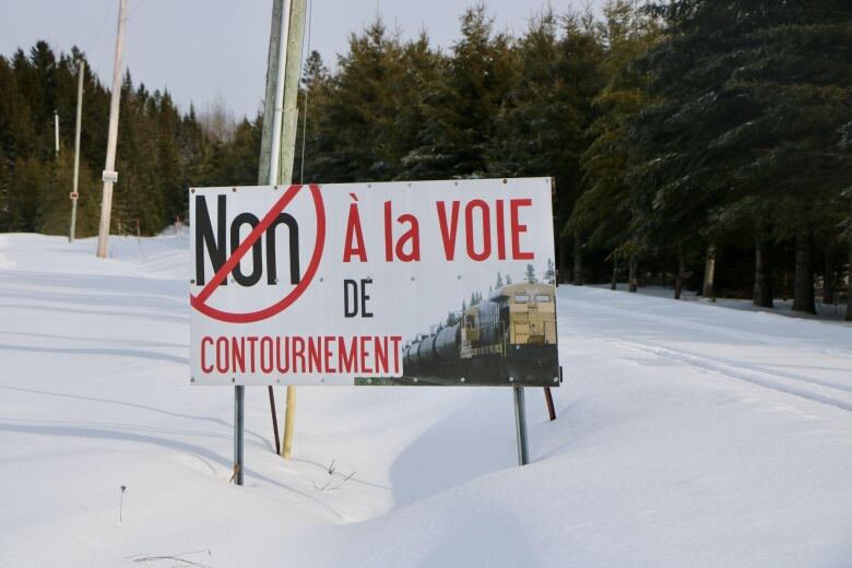 A sign reads in french no to the bypass rail system 