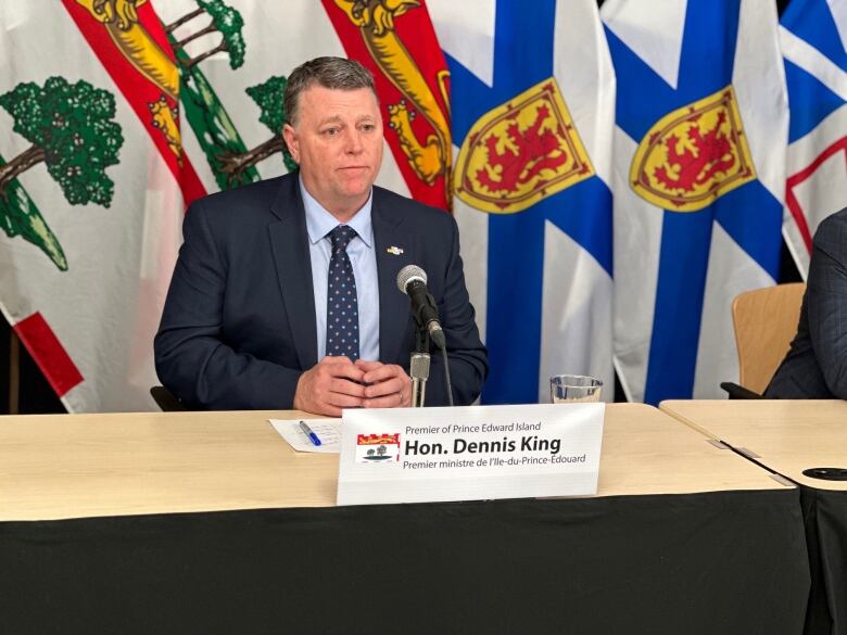 Premier Dennis King sitting at a desk.