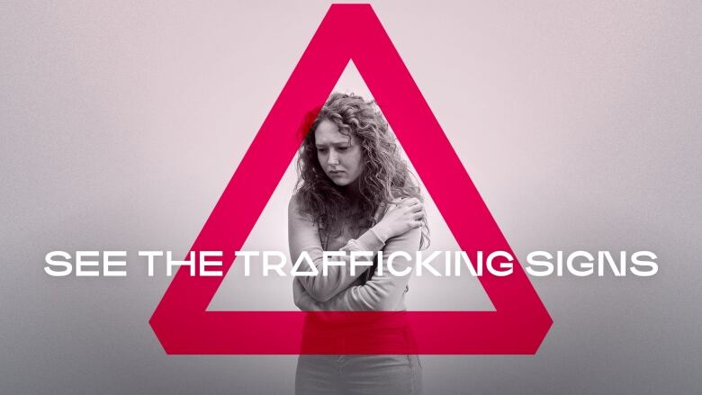 A girl with long hair and holding her arms around her upper body, stands inside a glowing red triangle with the words 