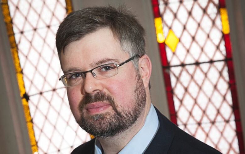 person with stained glass in background