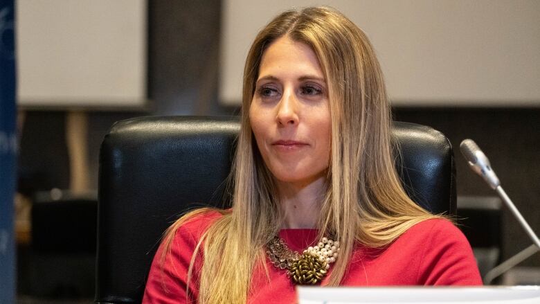 A woman listens at a city meeting.