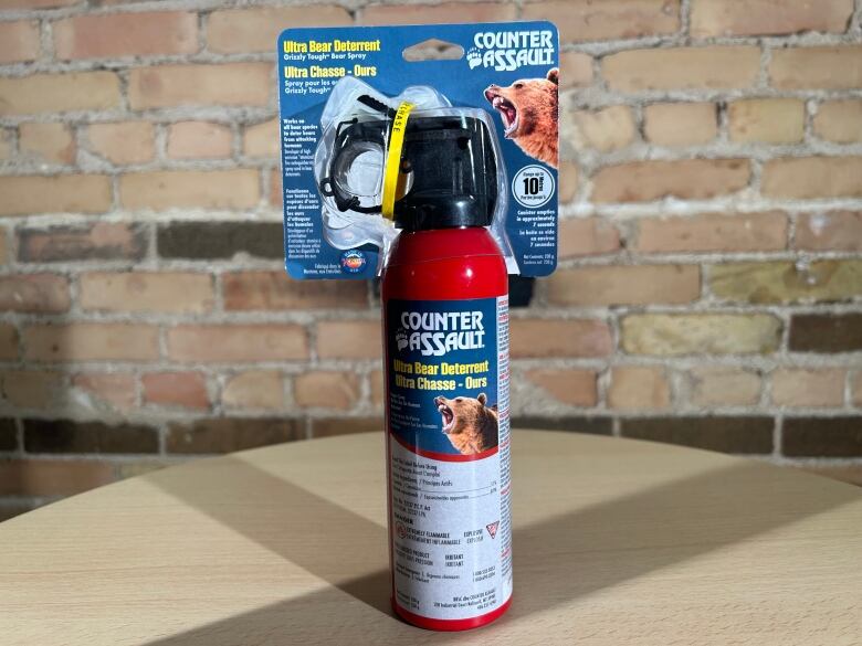 A red spray canister with the words counter assault is pictured.