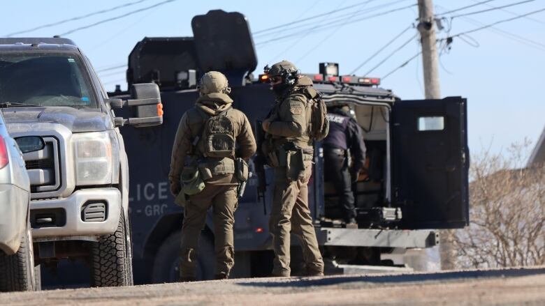 Heavily armed RCMP officers could be seen outside a home on 74th Street in Eskasoni on February 22, 2023. 