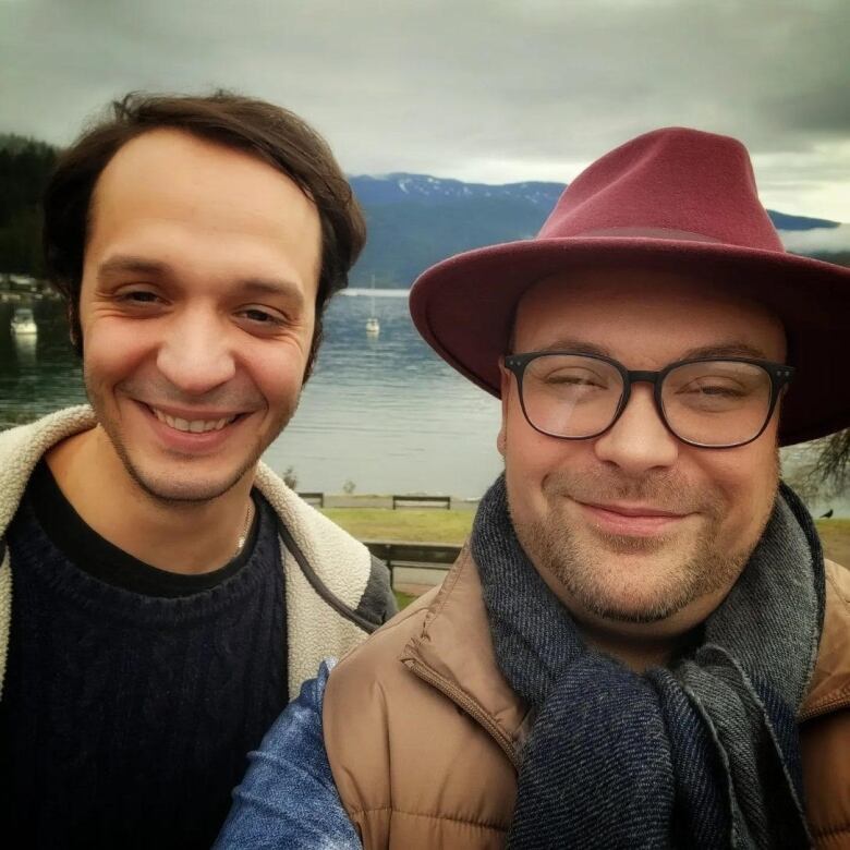 Two men seen taking a selfie.